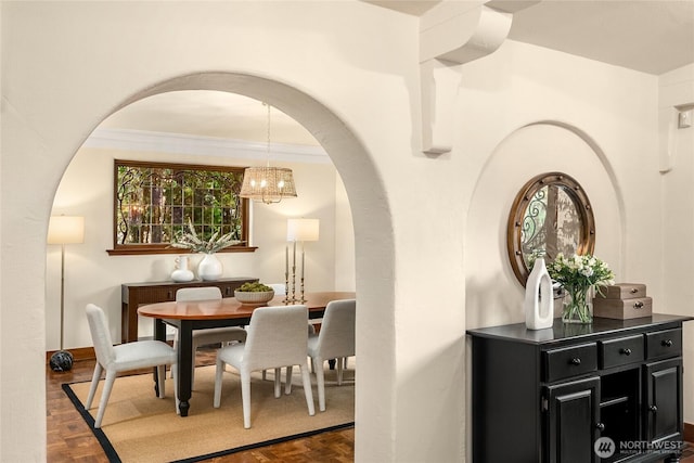 1919 Shenandoah Dr E, Seattle, WA 98112 - dining room featuring arched walkways, a chandelier, baseboards, and ornamental molding