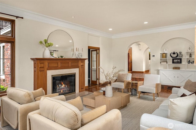 1919 Shenandoah Dr E, Seattle, WA 98112 - living area featuring arched walkways, ornamental molding, wood finished floors, recessed lighting, and a fireplace
