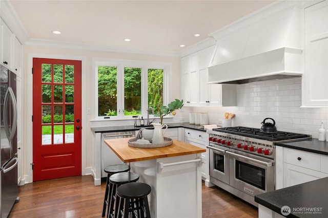 1919 Shenandoah Dr E, Seattle, WA 98112 - kitchen featuring stainless steel appliances, butcher block countertops, a sink, white cabinets, and backsplash