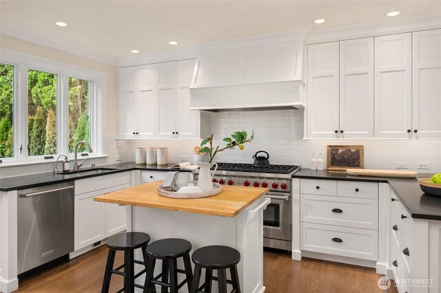 1919 Shenandoah Dr E, Seattle, WA 98112 - kitchen featuring a sink, stainless steel appliances, wood counters, white cabinets, and recessed lighting