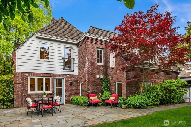 1919 Shenandoah Dr E, Seattle, WA 98112 - back of house with a patio, brick siding, and a chimney