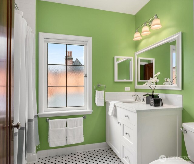 1919 Shenandoah Dr E, Seattle, WA 98112 - bathroom with vanity, toilet, a water view, and baseboards