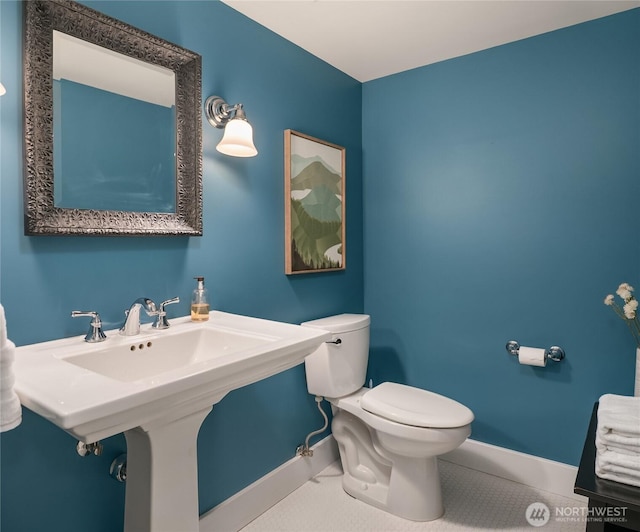 1919 Shenandoah Dr E, Seattle, WA 98112 - half bathroom featuring toilet, baseboards, and tile patterned flooring