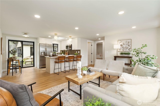 living area with recessed lighting and light wood-type flooring
