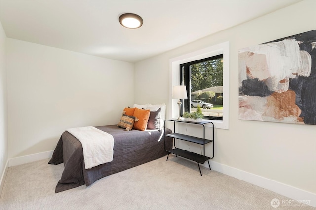 carpeted bedroom featuring baseboards