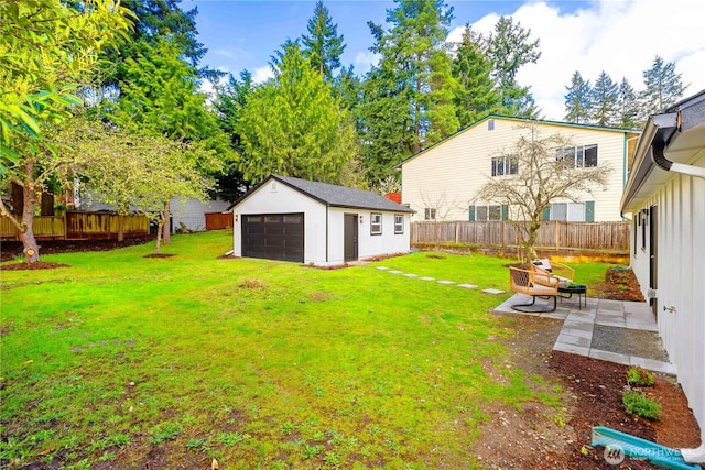 view of yard featuring a fenced backyard, an outdoor structure, a patio, and a garage