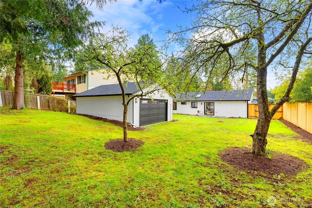 view of yard featuring a fenced backyard and a garage