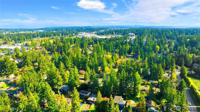 birds eye view of property with a wooded view