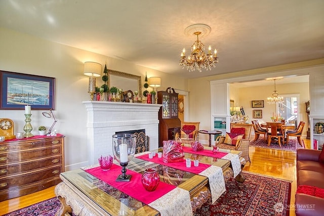 1305 10th St, Everett, WA 98201 - living room with a chandelier, light wood-style floors, and a fireplace