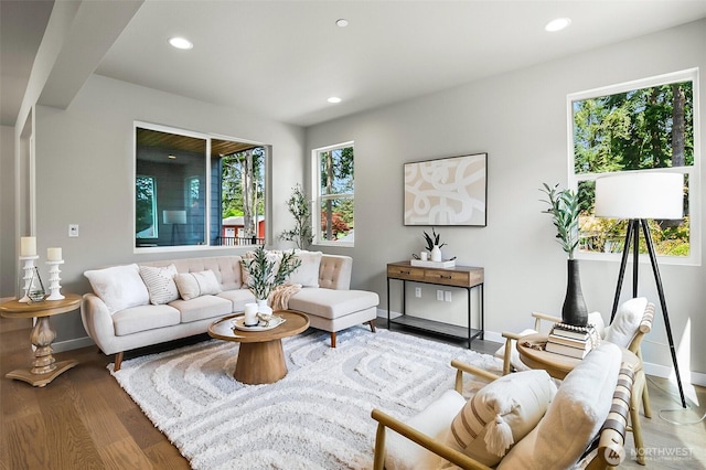 living room featuring baseboards, recessed lighting, and wood finished floors