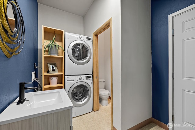 clothes washing area featuring a sink, stacked washer and clothes dryer, light floors, and laundry area