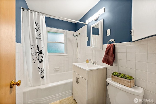 full bathroom featuring shower / tub combo with curtain, vanity, tile walls, and toilet