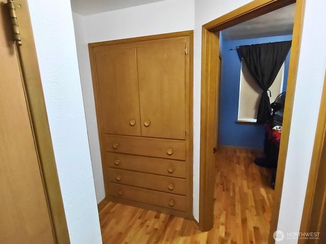 hallway with light wood-style floors