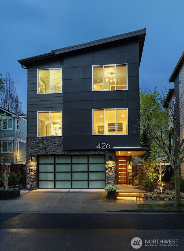 426 3rd Ct NW, Issaquah, WA 98027 - modern home featuring an attached garage, driveway, and stone siding
