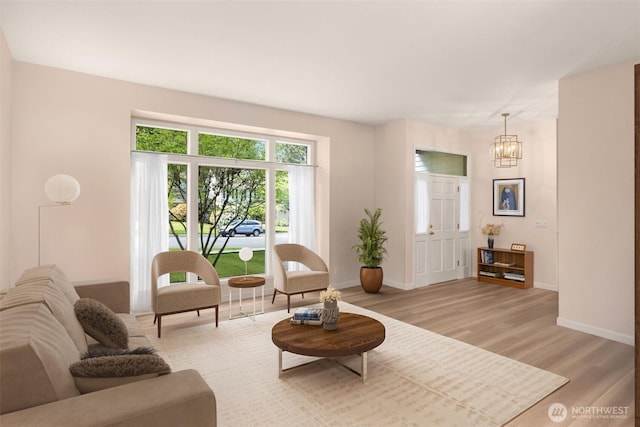 24507 SE 37th St, Sammamish, WA 98029 - living area with light wood-type flooring, baseboards, and a chandelier
