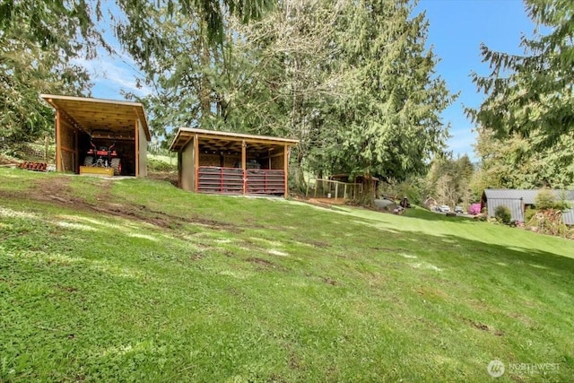 view of yard with an outbuilding and a pole building