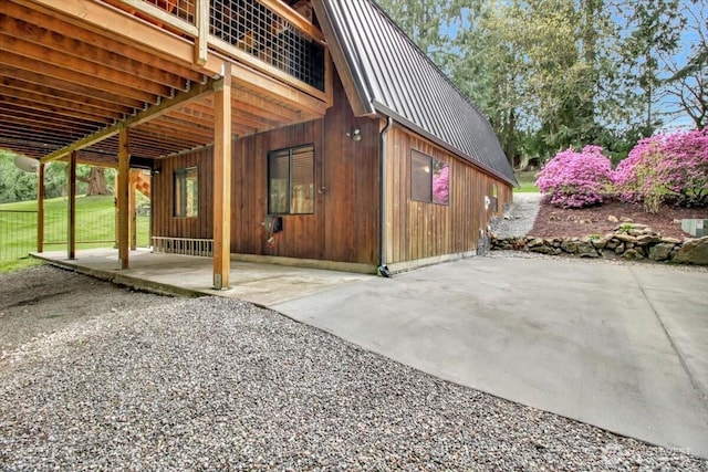 view of home's exterior featuring metal roof and a patio area