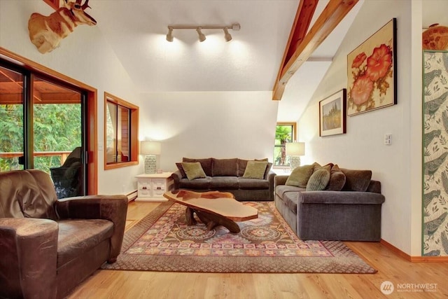 living room with track lighting, baseboards, wood finished floors, vaulted ceiling with beams, and a baseboard heating unit