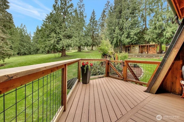 wooden deck featuring a yard