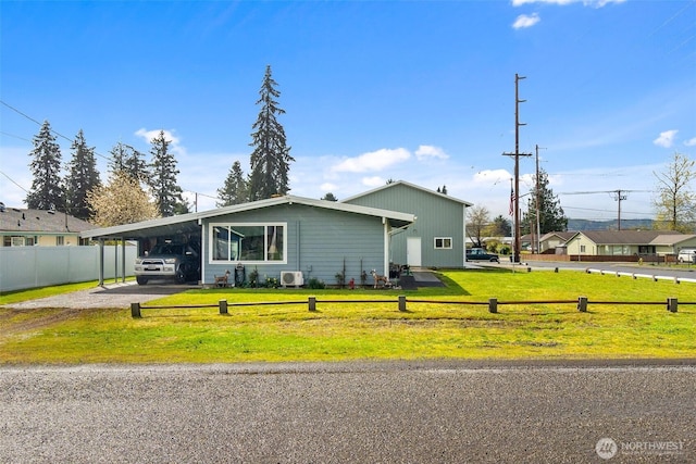 view of front of property with a carport, driveway, fence, and a front lawn