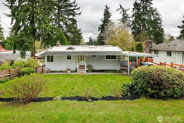 15544 Densmore Ave N, Shoreline, WA 98133 - rear view of house with a carport, a chimney, fence, and a lawn