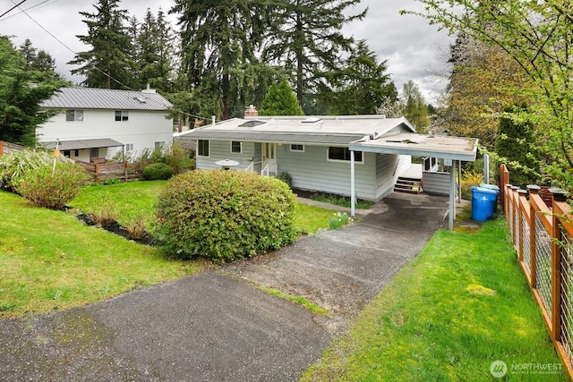 15544 Densmore Ave N, Shoreline, WA 98133 - rear view of house with aphalt driveway, fence, and a lawn