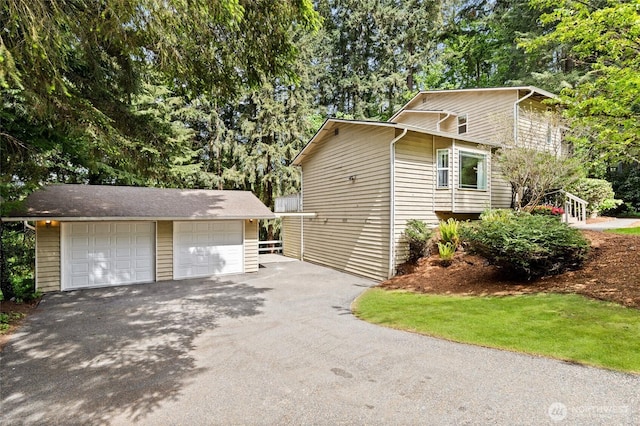 20817 29th Ave SE, Bothell, WA 98021 - view of property exterior featuring an outbuilding, a detached garage, and view of scattered trees
