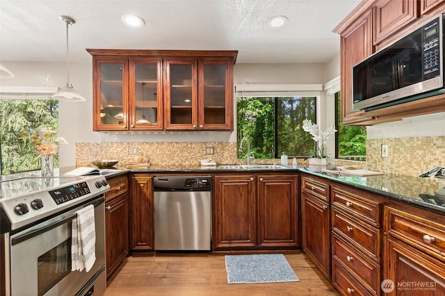 20817 29th Ave SE, Bothell, WA 98021 - kitchen with appliances with stainless steel finishes, a sink, backsplash, hanging light fixtures, and dark stone counters