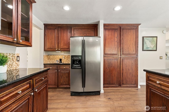 20817 29th Ave SE, Bothell, WA 98021 - kitchen with stainless steel fridge with ice dispenser, backsplash, light wood-type flooring, recessed lighting, and glass insert cabinets