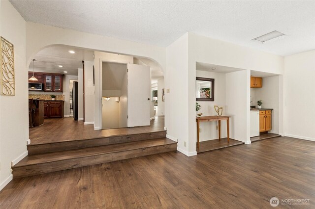 20817 29th Ave SE, Bothell, WA 98021 - foyer entrance with dark wood-style flooring, arched walkways, baseboards, and recessed lighting