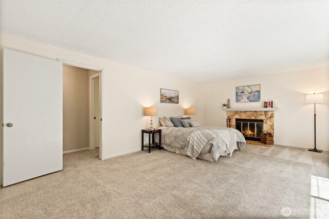 20817 29th Ave SE, Bothell, WA 98021 - bedroom with carpet flooring, a fireplace, a textured ceiling, and baseboards
