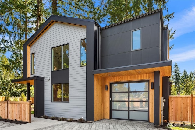 contemporary home featuring fence
