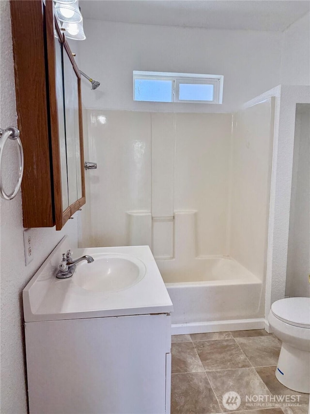 bathroom featuring toilet, shower / bathing tub combination, and vanity