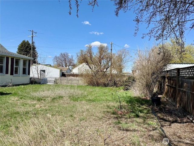 view of yard with a fenced backyard
