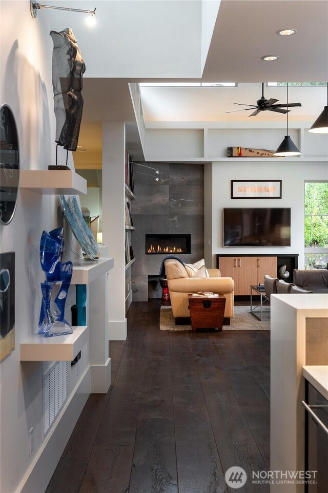 11116 SE 4th St, Bellevue, WA 98004 - living area featuring dark wood-type flooring, a glass covered fireplace, and a ceiling fan
