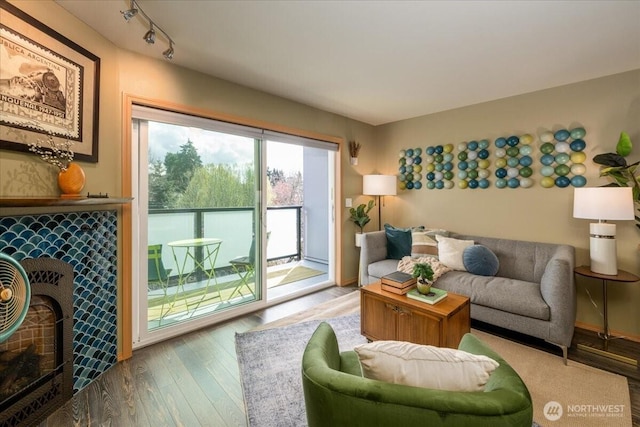 3435 California Ave SW Unit 405, Seattle, WA 98116 - living area featuring wood finished floors, rail lighting, and a tile fireplace