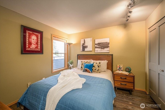 3435 California Ave SW Unit 405, Seattle, WA 98116 - bedroom with track lighting, baseboards, and wood finished floors