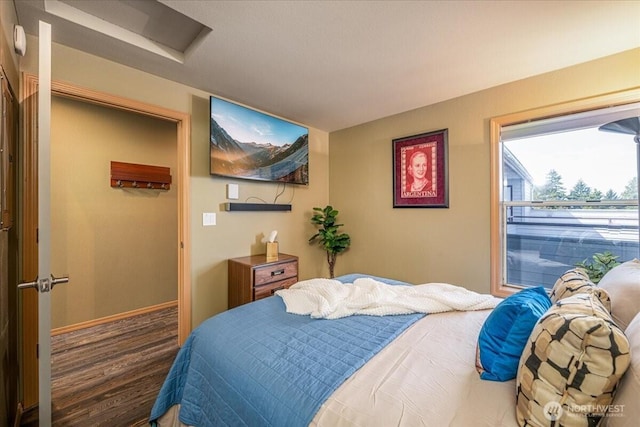 3435 California Ave SW Unit 405, Seattle, WA 98116 - bedroom with wood finished floors, attic access, and baseboards