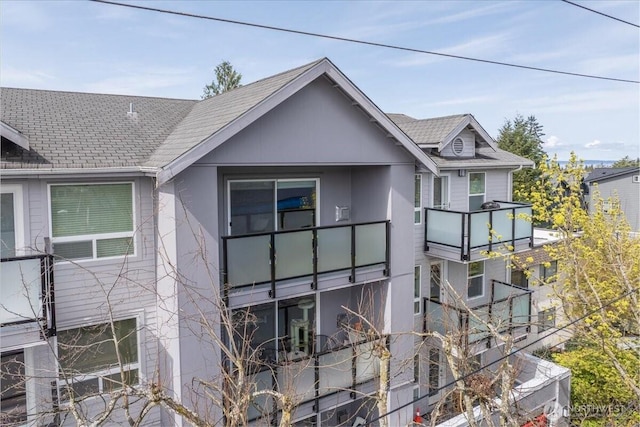3435 California Ave SW Unit 405, Seattle, WA 98116 - view of home's exterior featuring a shingled roof