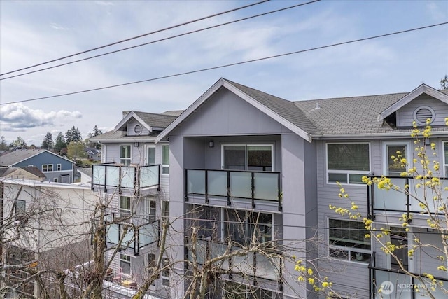 3435 California Ave SW Unit 405, Seattle, WA 98116 - view of front facade with a shingled roof