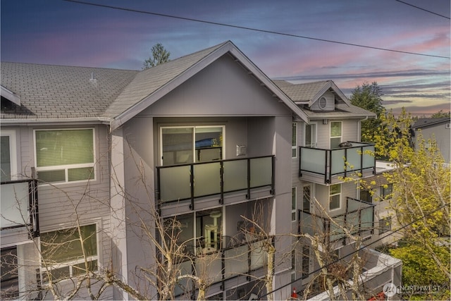 3435 California Ave SW Unit 405, Seattle, WA 98116 - view of side of property featuring a shingled roof