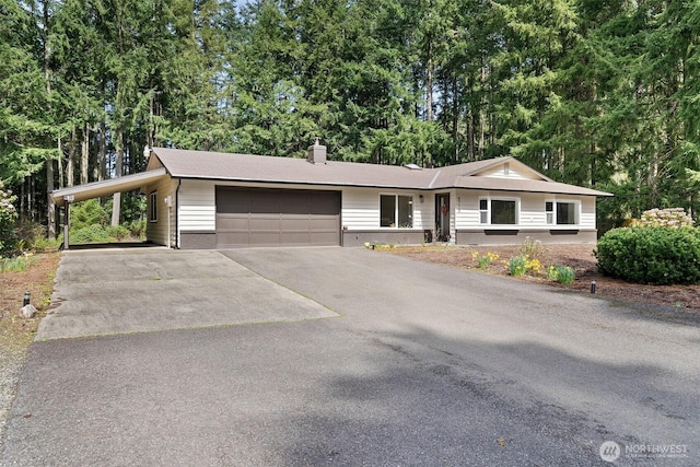 8710 Homestead Ave NE, Olympia, WA 98516 - ranch-style home with asphalt driveway, a chimney, a garage, brick siding, and an attached carport