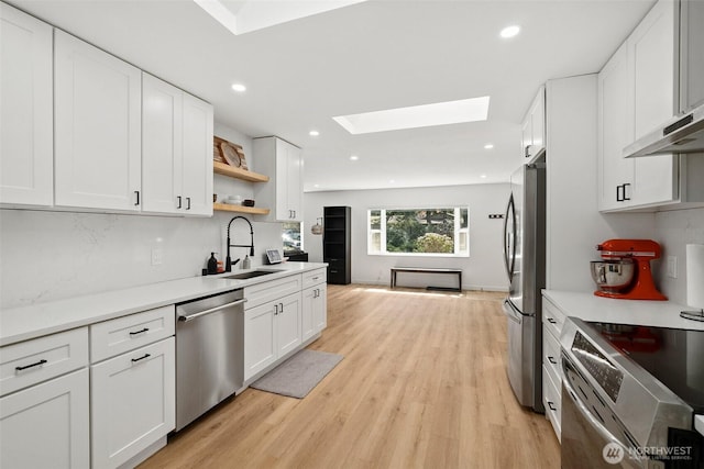 8710 Homestead Ave NE, Olympia, WA 98516 - kitchen with tasteful backsplash, appliances with stainless steel finishes, recessed lighting, a skylight, and a sink