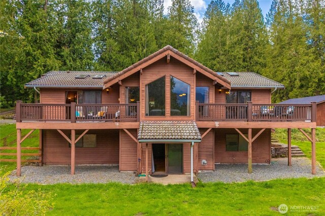 37902 278th Ave SE, Enumclaw, WA 98022 - rear view of house with a lawn, a tiled roof, and a wooden deck
