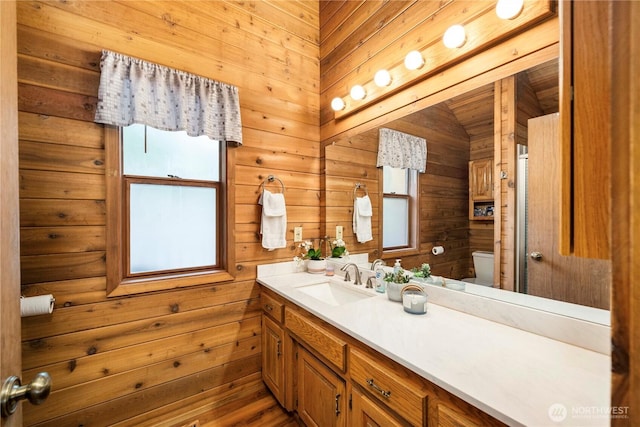37902 278th Ave SE, Enumclaw, WA 98022 - bathroom featuring toilet, a wealth of natural light, wooden walls, and vanity