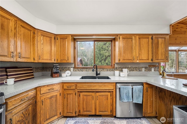37902 278th Ave SE, Enumclaw, WA 98022 - kitchen with backsplash, dishwasher, brown cabinets, and a sink