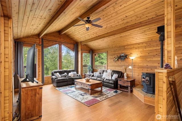 37902 278th Ave SE, Enumclaw, WA 98022 - living room with a wood stove, a wealth of natural light, lofted ceiling with beams, and ceiling fan