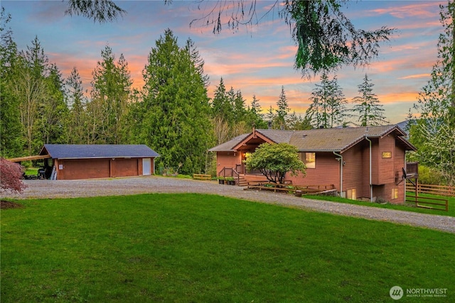 37902 278th Ave SE, Enumclaw, WA 98022 - view of front of house with gravel driveway, a front yard, a tile roof, and a detached garage