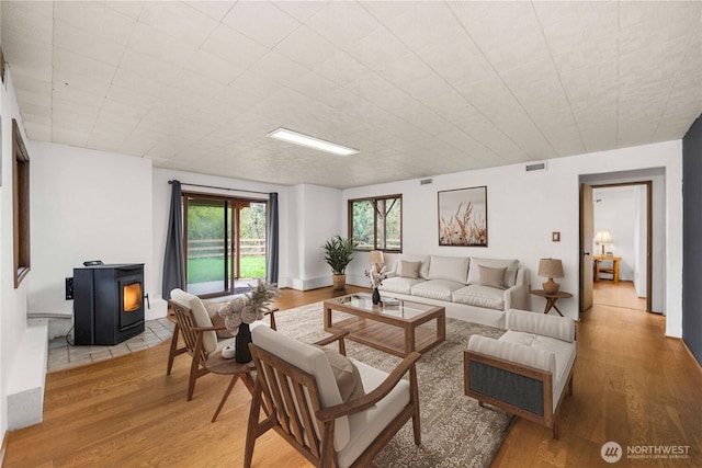 37902 278th Ave SE, Enumclaw, WA 98022 - living area featuring a wood stove, light wood-type flooring, and visible vents