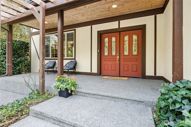 doorway to property featuring a porch and a pergola